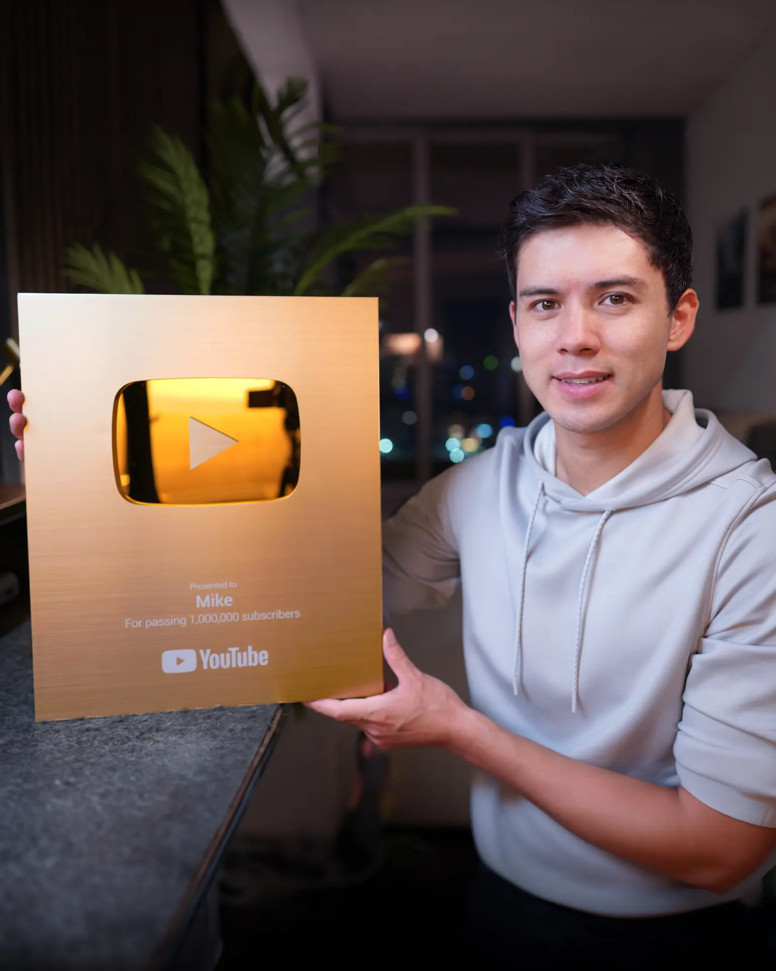 Mike Dee holding his YouTube Gold Play Button